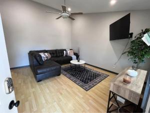 a living room with a couch and a flat screen tv at The Coffee House in Lexington
