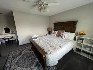 a bedroom with a large bed with a ceiling fan at The Coffee House in Lexington