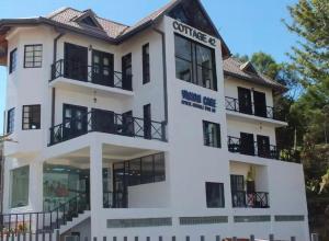 a white building with windows and balconies at Cottage 43 in Nuwara Eliya