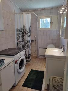 a bathroom with a washing machine and a sink at Koivistonpiha farmstay in Valkeakoski +24 photos