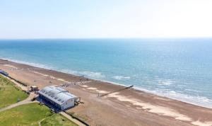 an observatory on a beach next to the ocean at South Downs Retreat in Sompting +11 photos