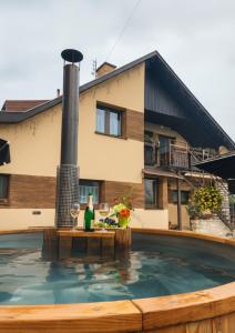 a swimming pool in front of a house at Privát Prima in Liptovský Ján