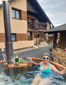 a woman in the swimming pool at a hotel at Privát Prima in Liptovský Ján