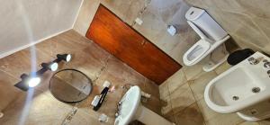 a bathroom with a sink and a toilet and a mirror at Ribera Calma in Los Reartes +16 photos