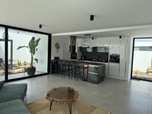 a kitchen and living room with a couch and a table at Stylish and comfortable Villa Anna in Villaverde in Lajares