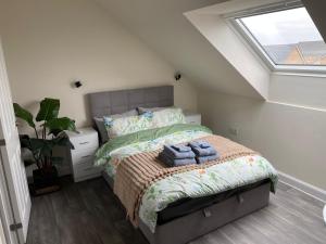 a bedroom with a bed with two towels on it at The Cottontail - Modern Private Room With Breakfast - Tamworth in Tamworth