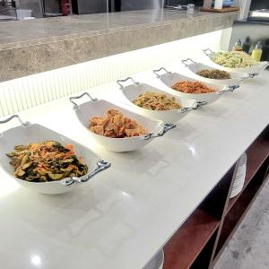 a table with four bowls of food on it at Hotel PIED Suseong in Daegu
