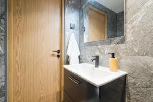 a bathroom with a sink and a mirror at Elegant 28m2 Studio Flat 3min Walk from Old Town in Tallinn +18 photos