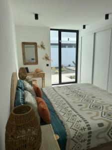 a bedroom with a bed and a view of the ocean at Stylish and comfortable Villa Anna in Villaverde in Lajares