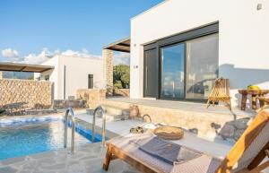 a villa with a swimming pool and a house at Casatino Villas in Kalianeika