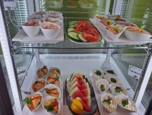 a refrigerator filled with lots of different types of food at Hotel Altes Salzamt in Bad Dürrenberg