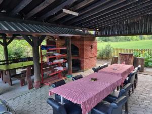a patio with a table and chairs and a fireplace at Dolina Mira in Srebrenik