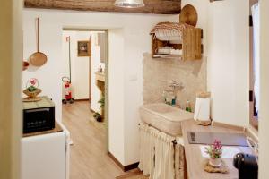 a small kitchen with a sink and a refrigerator at Rifugio dei Briganti in San Donato Val di Comino