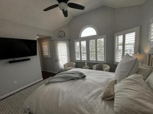 a bedroom with a large bed with a ceiling fan at Wifi Decks Private Yard Beach Badges Beach Chairs Keurig Os Wd 3Rd Off The Beach in Brant Beach