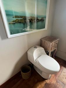 a toilet in a bathroom with a window at villa de los sueños in Bocas del Toro