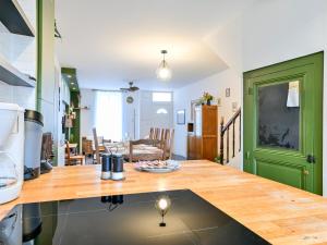 a kitchen with a counter top and a living room at La Casse Dorée - Terrasse & Gare à proximité in Cholet