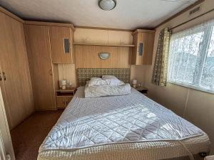 a bedroom with a large bed in a room at Ref 40035Nd - Superb Caravan With Decking & Free Wifi At North Denes Holiday Park in Lowestoft
