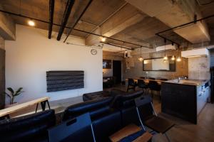 a living room with leather furniture and a table at Shimoda Shirahama Sun Sea - Vacation STAY 17357v in Shimoda