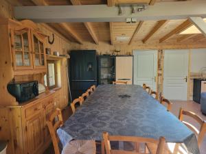 a dining room with a blue table and chairs at chez Alex et Francesca in Sainte-Marie-de-Cuines