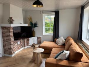 a living room with a couch and a fireplace at Bij Liezeke in Zemst