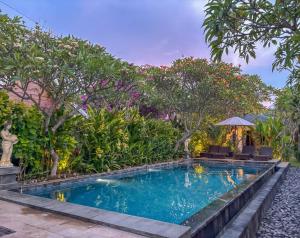a swimming pool in a garden with trees at Singabu Bungalows in Nusa Penida +43 photos