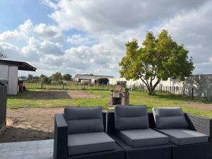 a couple of chairs sitting on a patio at Bij Liezeke in Zemst