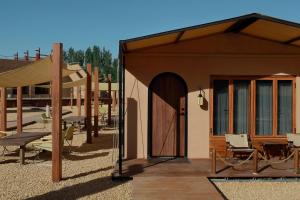 a small building with a porch and a patio at DunHuang FengMingSha Hotel in Dunhuang