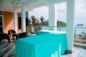 a blue table on a balcony with a view at Kivu Hilltop View Hotel & Apartment in Taba