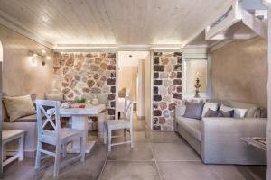 a living room with a couch and a table and chairs at Luxury Villas Hariton in Emporio +41 photos