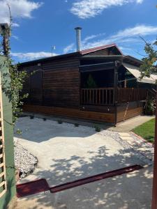 a house with a fence and a patio at Ξύλινη Φωλιά - Wooden Nest in Tríkala