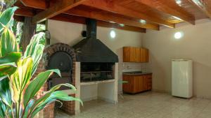 a kitchen with a brick oven in a room at Hotel Che Roga in Puerto Eldorado