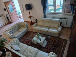 a living room with a couch and a table at La casa di ale in Latina