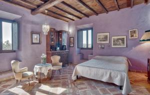 a bedroom with a bed and a table and chairs at Holiday Home Montefiascone 96 With Outdoor Swimmingpool in Ranucci