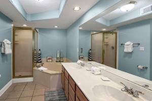 a bathroom with two sinks and a large mirror at Sandpiper 304 in Tybee Island +30 photos