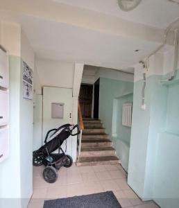 a hallway with a stroller in a room with stairs at Quiet and comfortable apartment in Rakvere +1 photo