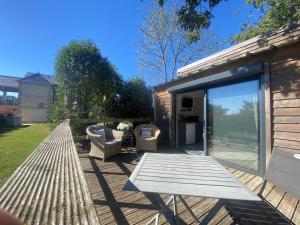 a patio with a table and chairs and a house at Chalet Olisios, priate accommodation in beautiful countryside location in Pampelonne