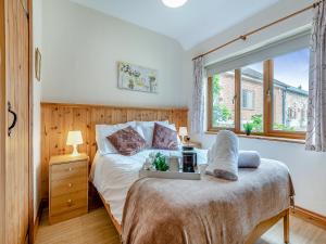 a bedroom with a bed and a large window at Stable - Uk49900 in Blandford Forum +30 photos