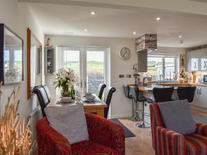 a kitchen and living room with a table and chairs at Mountain View in Morfa Bychan