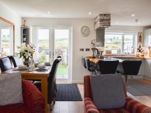 a kitchen and dining room with a table and chairs at Mountain View in Morfa Bychan