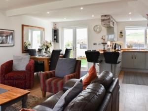 a living room with a couch and a table at Mountain View in Morfa Bychan