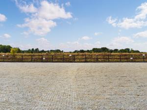 a fence in front of a field with animals at Saddlers - Uk50519 in Ovington