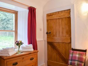 a bathroom with a wooden door and a window at St Orans in Rafford +10 photos