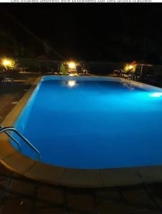 a large blue swimming pool at night at Moriani Plage San-Nicolao Les Marines de Moriani in San-Nicolao +9 photos