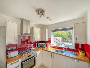 a kitchen with a sink and a stove top oven at Sealladh Apartment - Ukc6792 in Port Appin