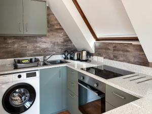 a kitchen with a sink and a washing machine at Torrin - Uk50497 in Kylestrome