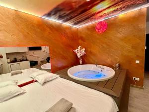a bathroom with a sink and a bed at MATTEO room by 50 shades in Baia Mare