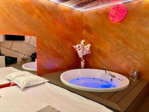a bathroom with a tub in the corner of a room at MATTEO room by 50 shades in Baia Mare