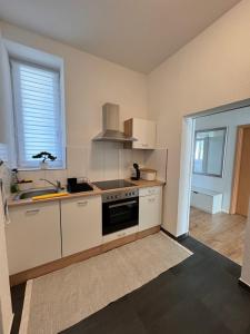 a kitchen with a sink and a stove top oven at 2 Bedroom Apartment at Grenzach train station in Grenzach-Wyhlen