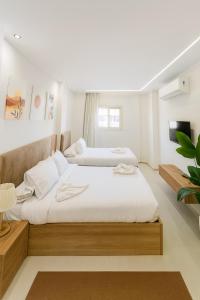 a bedroom with two beds and a tv at Diva Suites in Hurghada