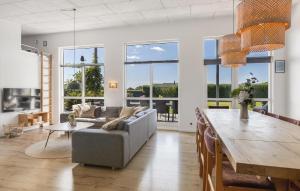 a living room with a couch and a table at Four-Bedroom Holiday Home Haderslev With A Room Hot Tub 01 in Knud